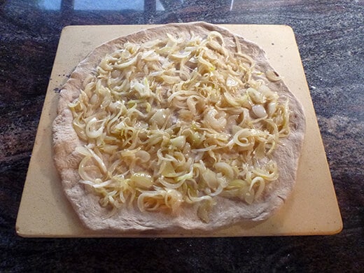 Roasted Fig Pizza with Caramelized Onion and Goat Cheese Top dough with caramelized onion slices