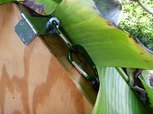 The Nuts and Bolts of the Tiki Coop Latch secured with a carabiner