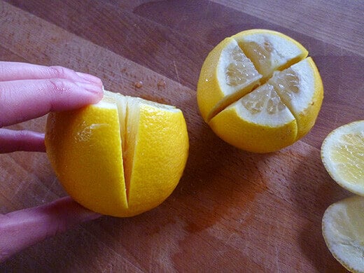Slice off the top and bottom, then slice lengthwise into almost-quarters