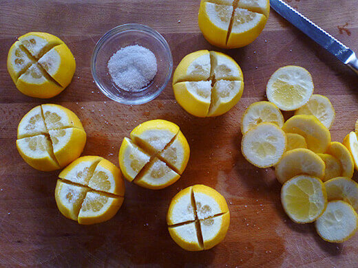 Liberally salt the insie of your almost-quartered lemons