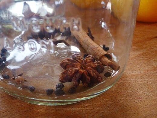 Add cinnamon stick, cloves, star anise, and black peppercorns to a jar