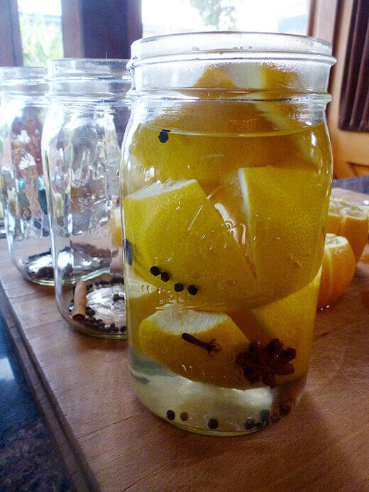 Pack lemons into a jar, then cover completely with brine