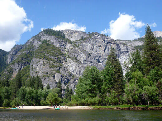 Floating Through Yosemite Valley on the Merced Sandy beach on the bank of the Merced