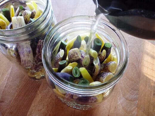Pickled Dilly Beans Pour hot brine over the beans