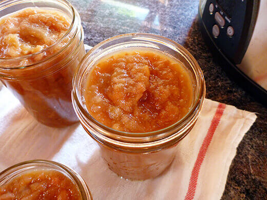 Funnel spiced apple-pear butter into hot, clean jars