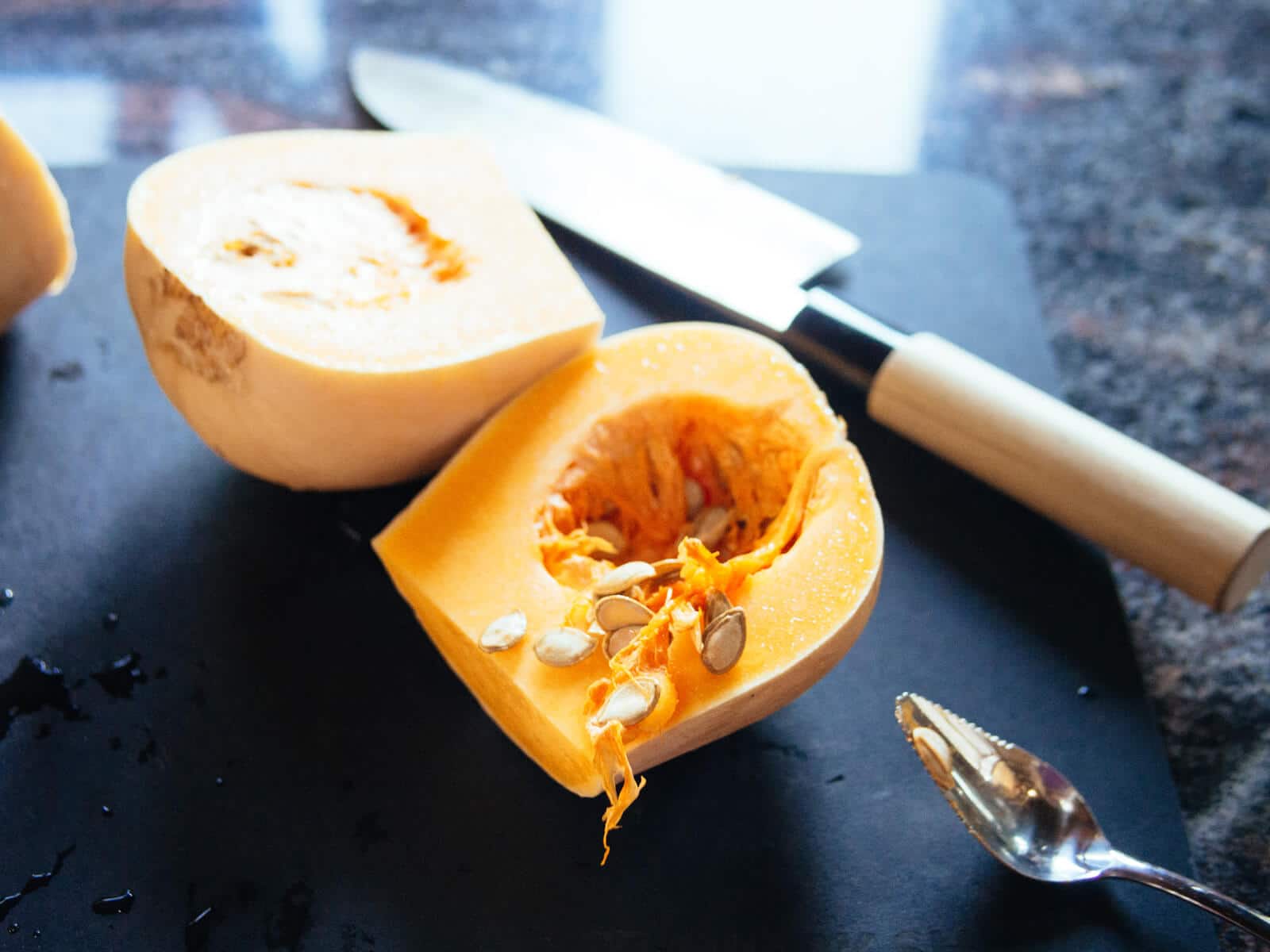 Scooping seeds from butternut squash