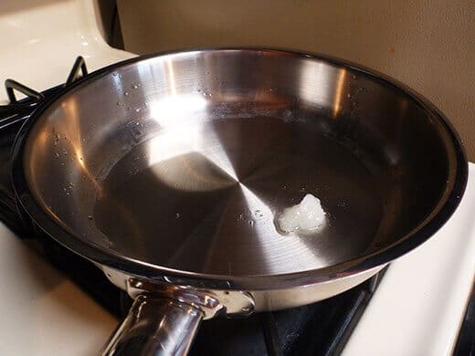 Melt coconut oil in a large saucepan over medium-low heat