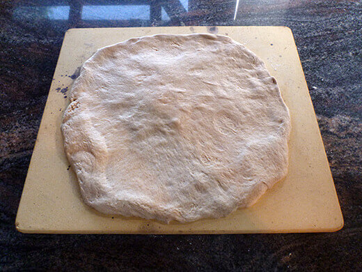 Stretch or roll out pizza dough