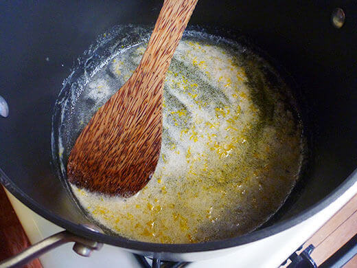 Melt butter and stir in sugar, cardamom, and orange zest