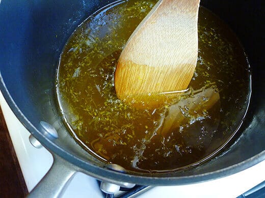 Combine lemon juice, lemon zest, honey, and pectin in a large pot