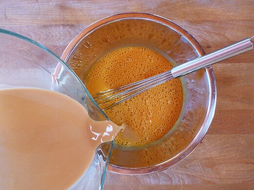 Whisk and temper the egg yolks