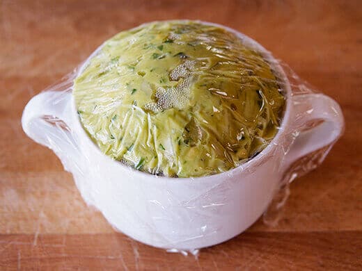 Seal the surface of the guacamole with plastic wrap to prevent browning