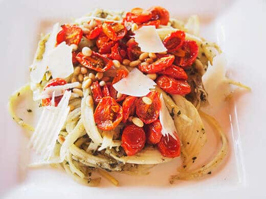 Zucchini noodles with roasted tomatoes, pesto, and pine nuts