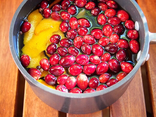 Apple cider, whole cranberries, orange peels, and mulling spices