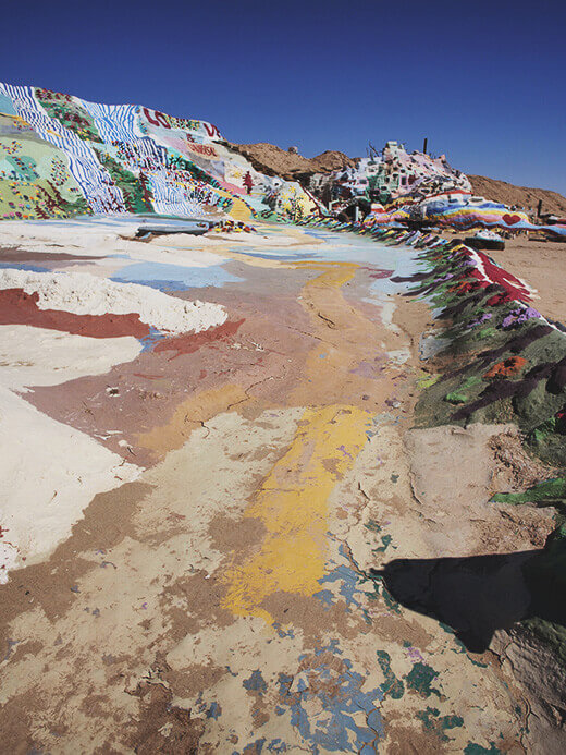 Straw, adobe, and paint adorn the hill