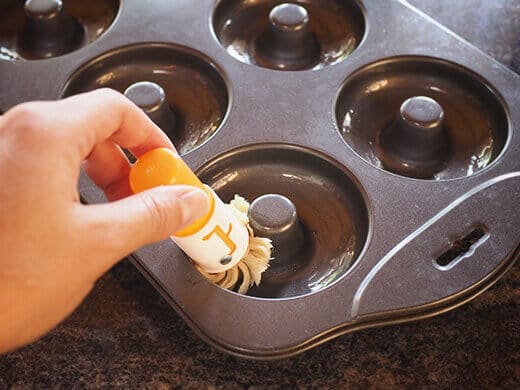 Brush oil into donut molds