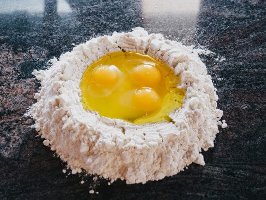 Crack each egg into the well