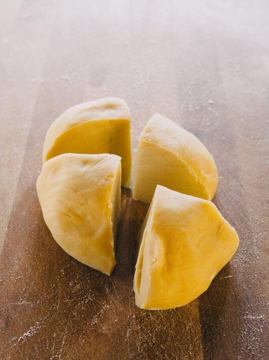 Cut the dough into quarters