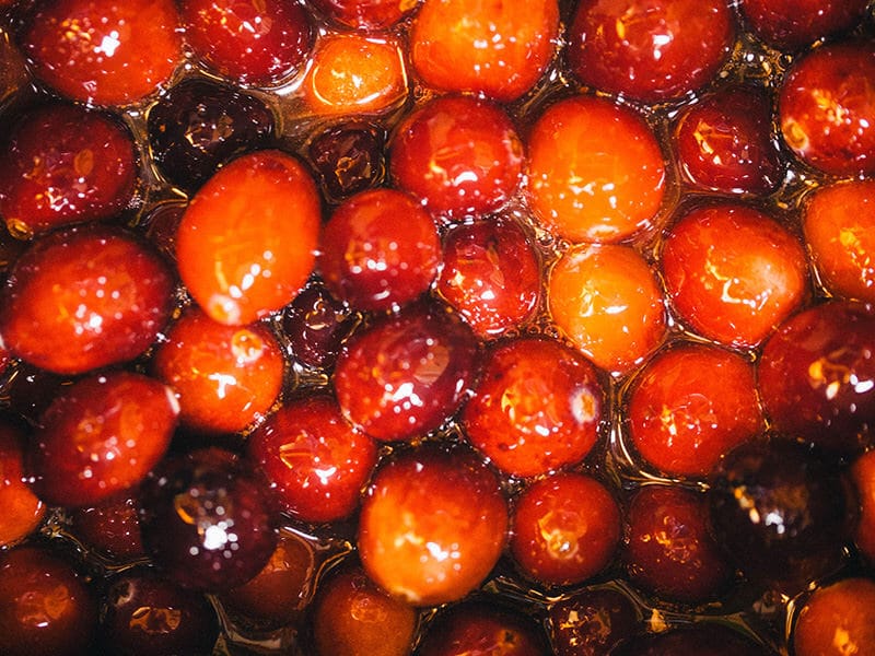 Heat cranberries with sugar, orange juice, and spices