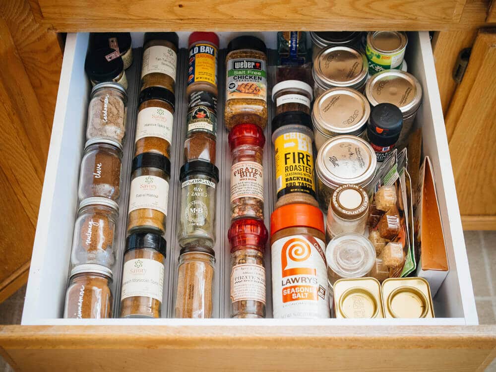 Spice bottles, jars, tubs, and tins neatly sorted in a drawer