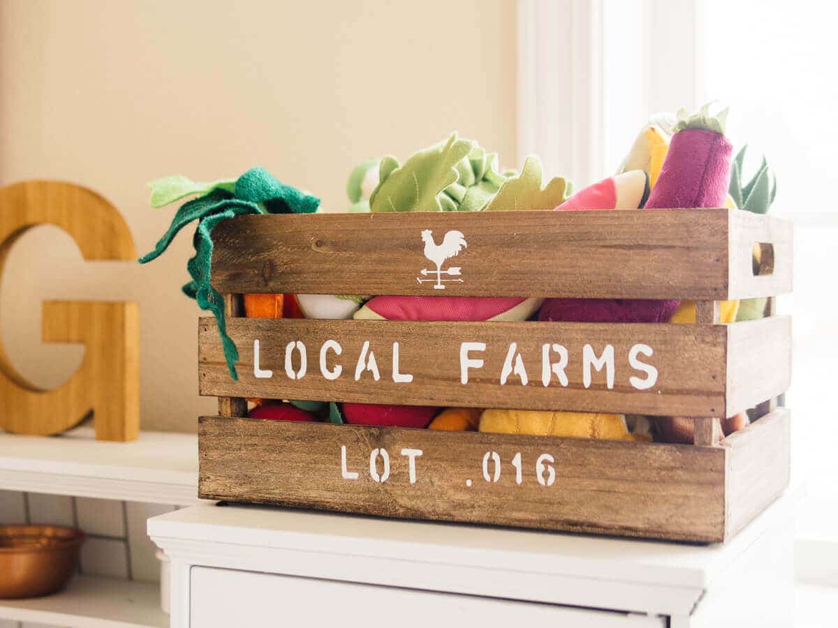 Felt fruits and vegetables in wooden farm crate