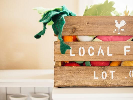 Rustic fruit and vegetable basket full of felt play food