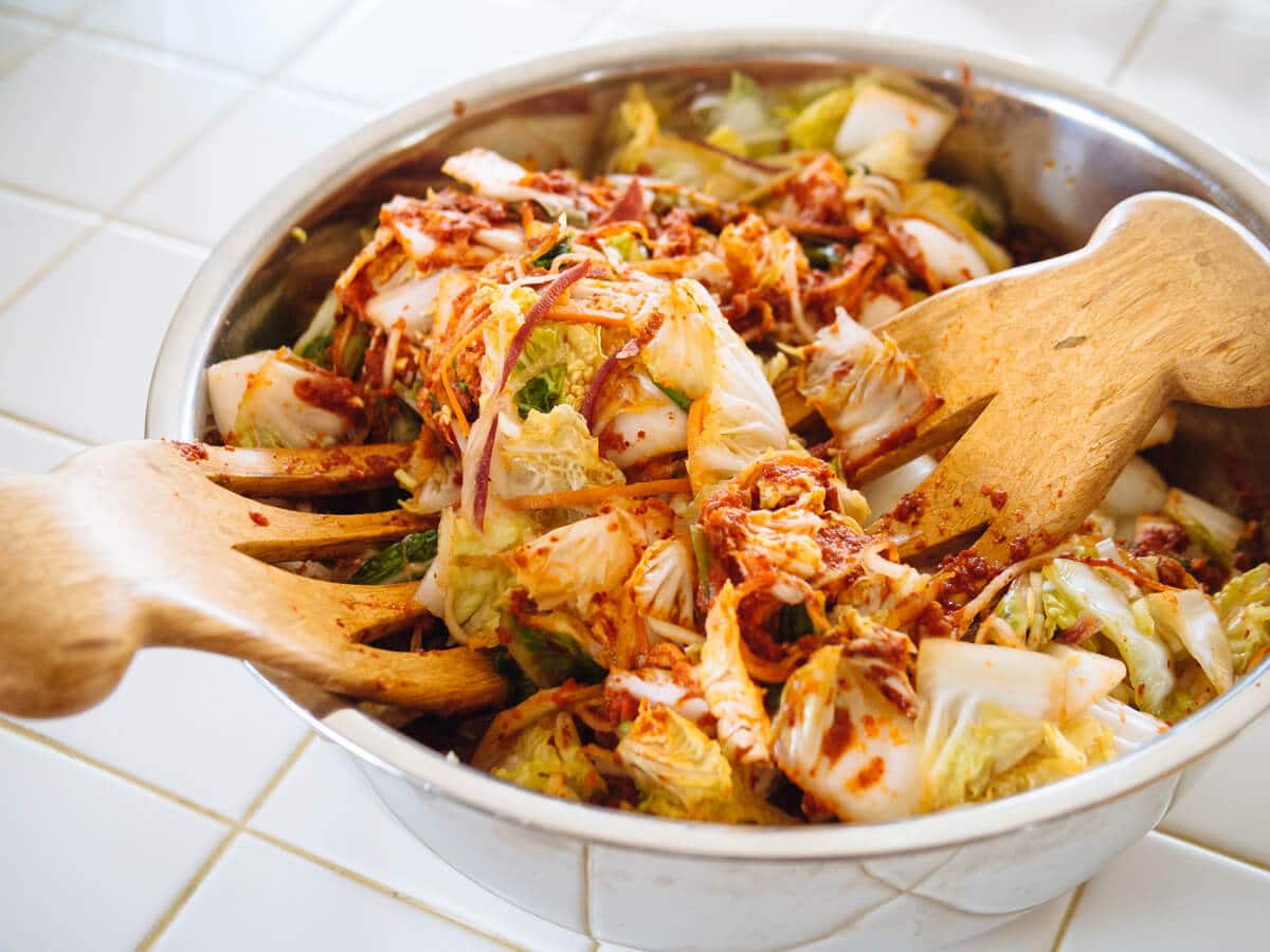 Toss the vegetables with kimchi sauce until evenly coated