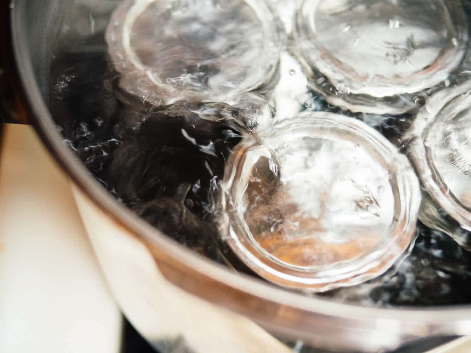 A stainless steel stockpot and round cooling rack can be used for canning