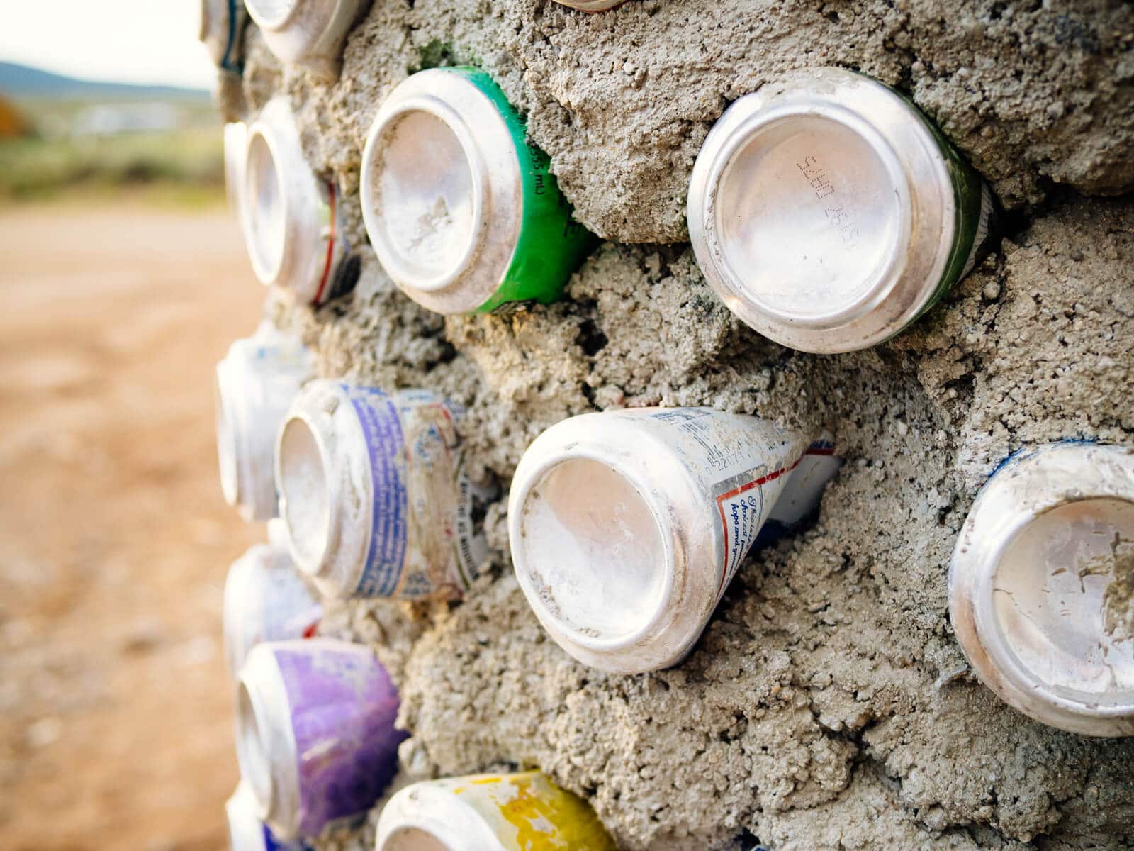 Aluminum cans laid in adobe mud to give structure to walls
