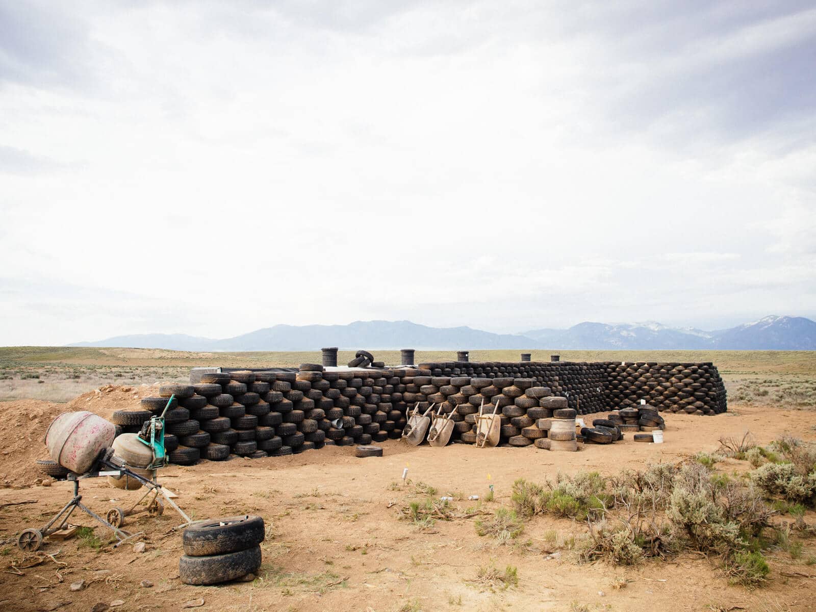 Recycled tires rammed with earth and stacked to form the exterior walls of an Earthship