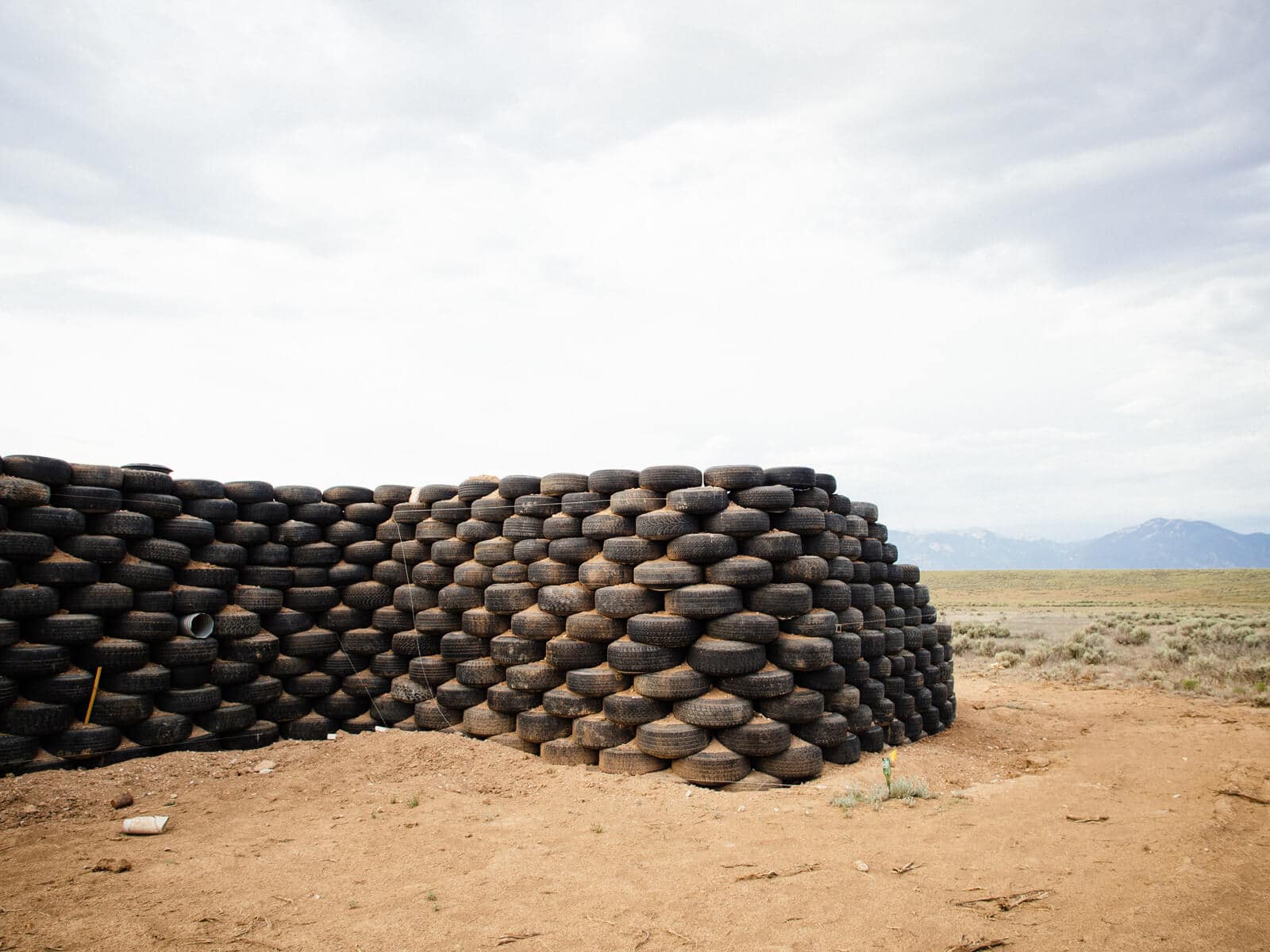 Rammed-earth tire walls in the beginning stages of an Earthship home