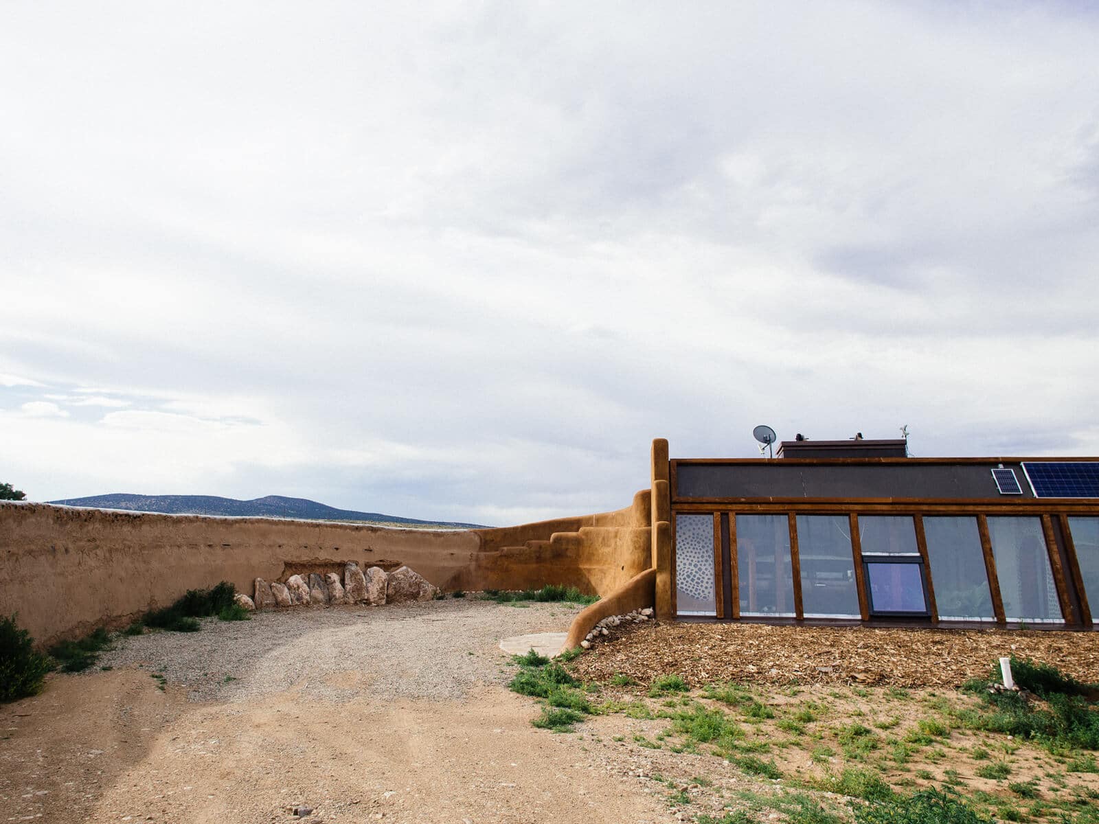 Driveway leading to the garage on an Earthship property
