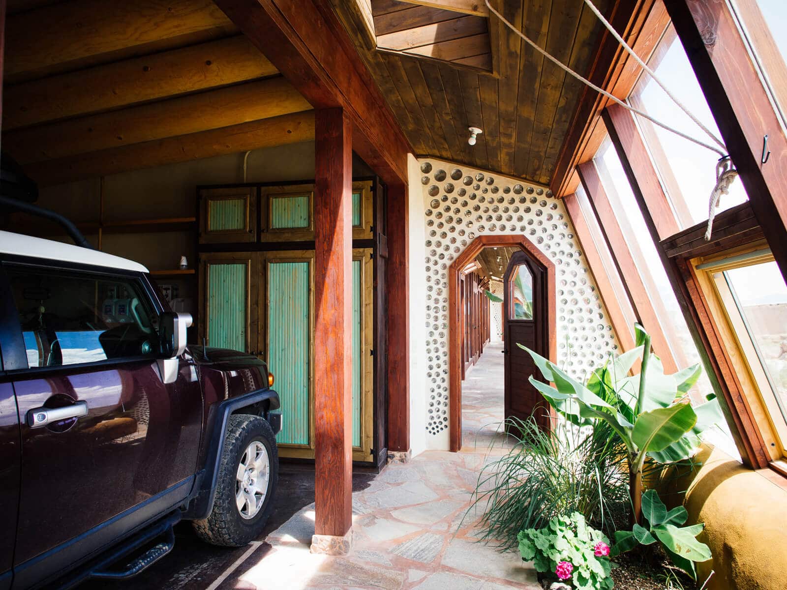 The garage is attached to the house in an Earthship