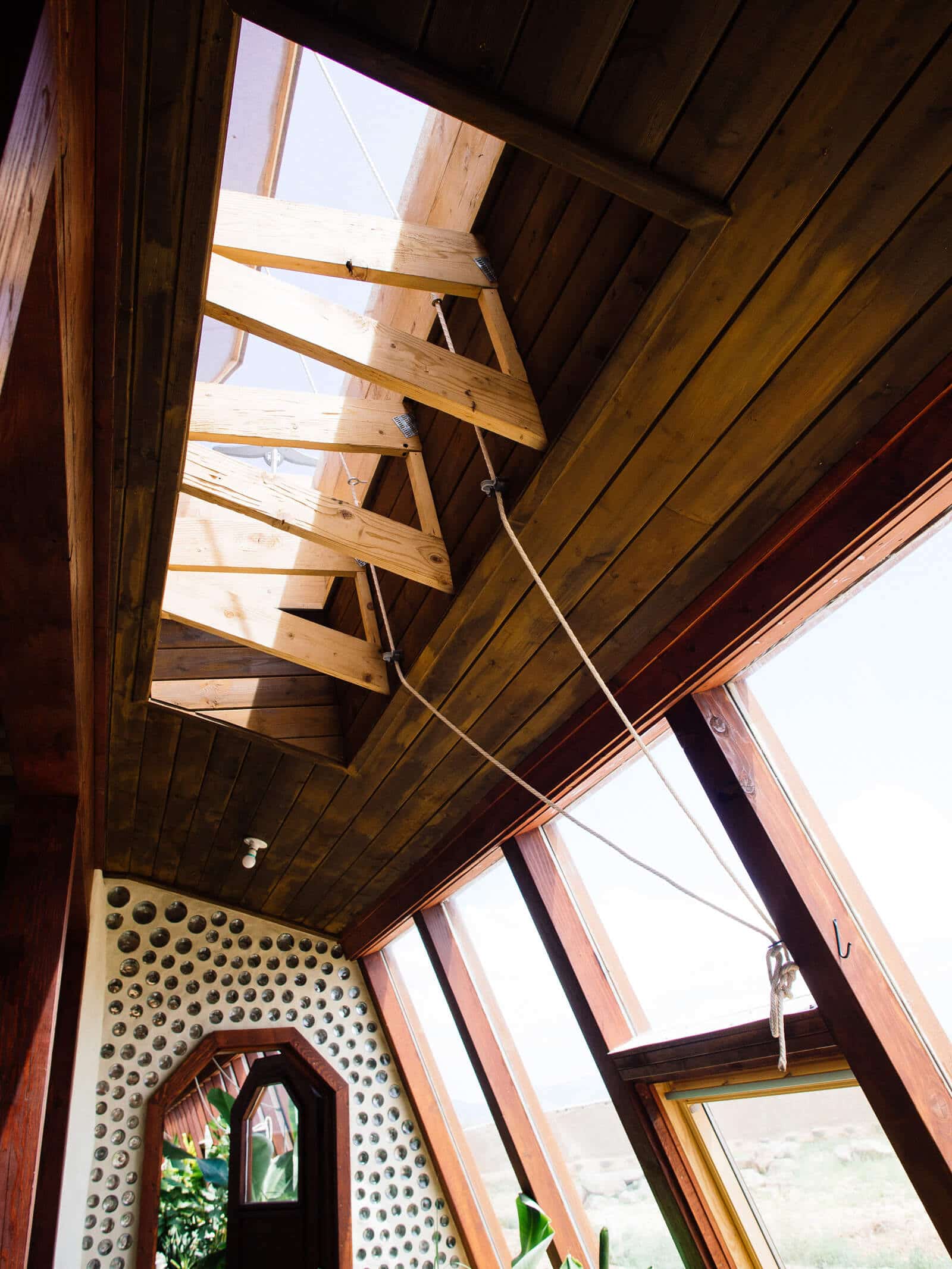Hand-cranked skylights in an Earthship greenhouse