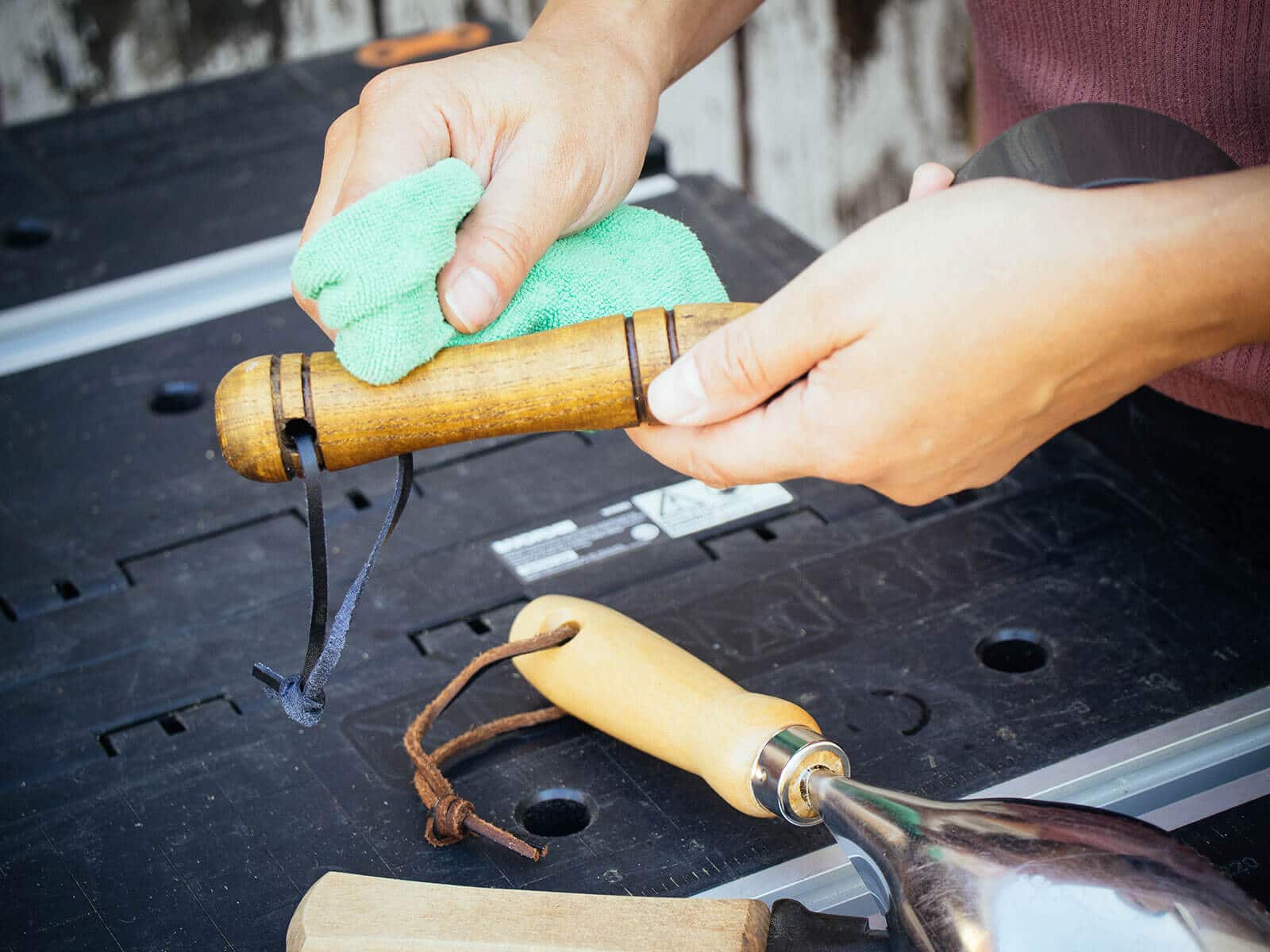 Hand buffing a freshly oiled wooden garden tool handle