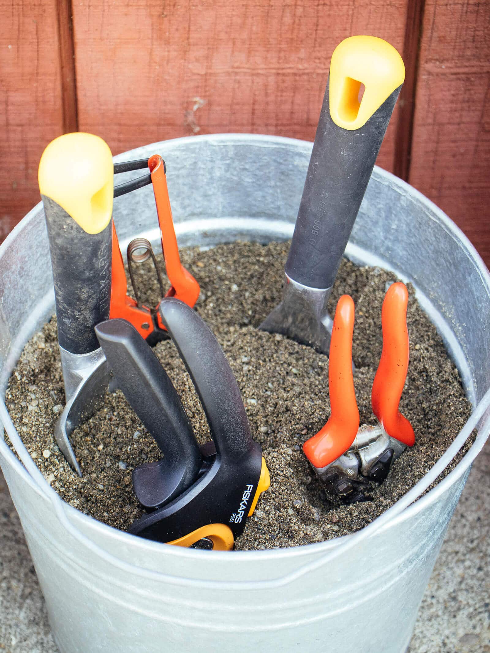 "Quick clean" sand bucket filled with garden tools