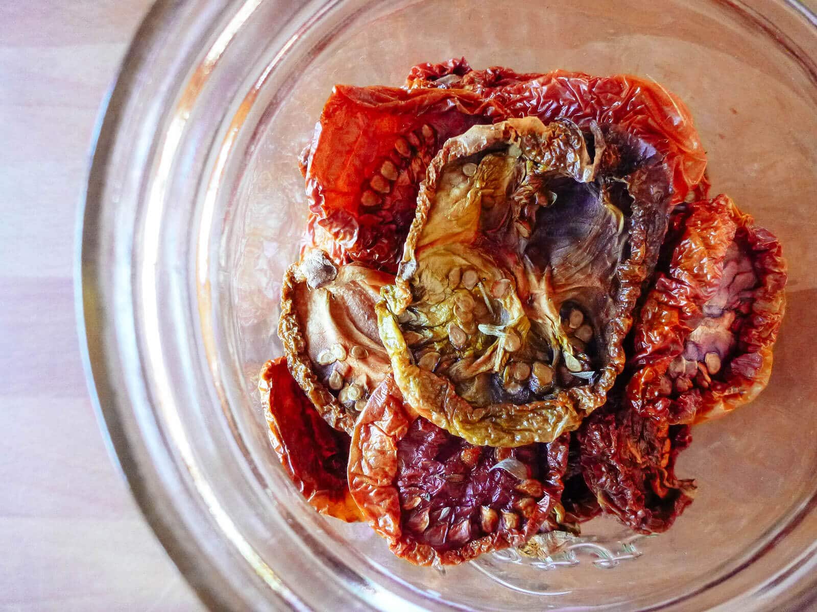 Overhead shot of sun-dried tomatoes (that were dried in the oven) in a jar