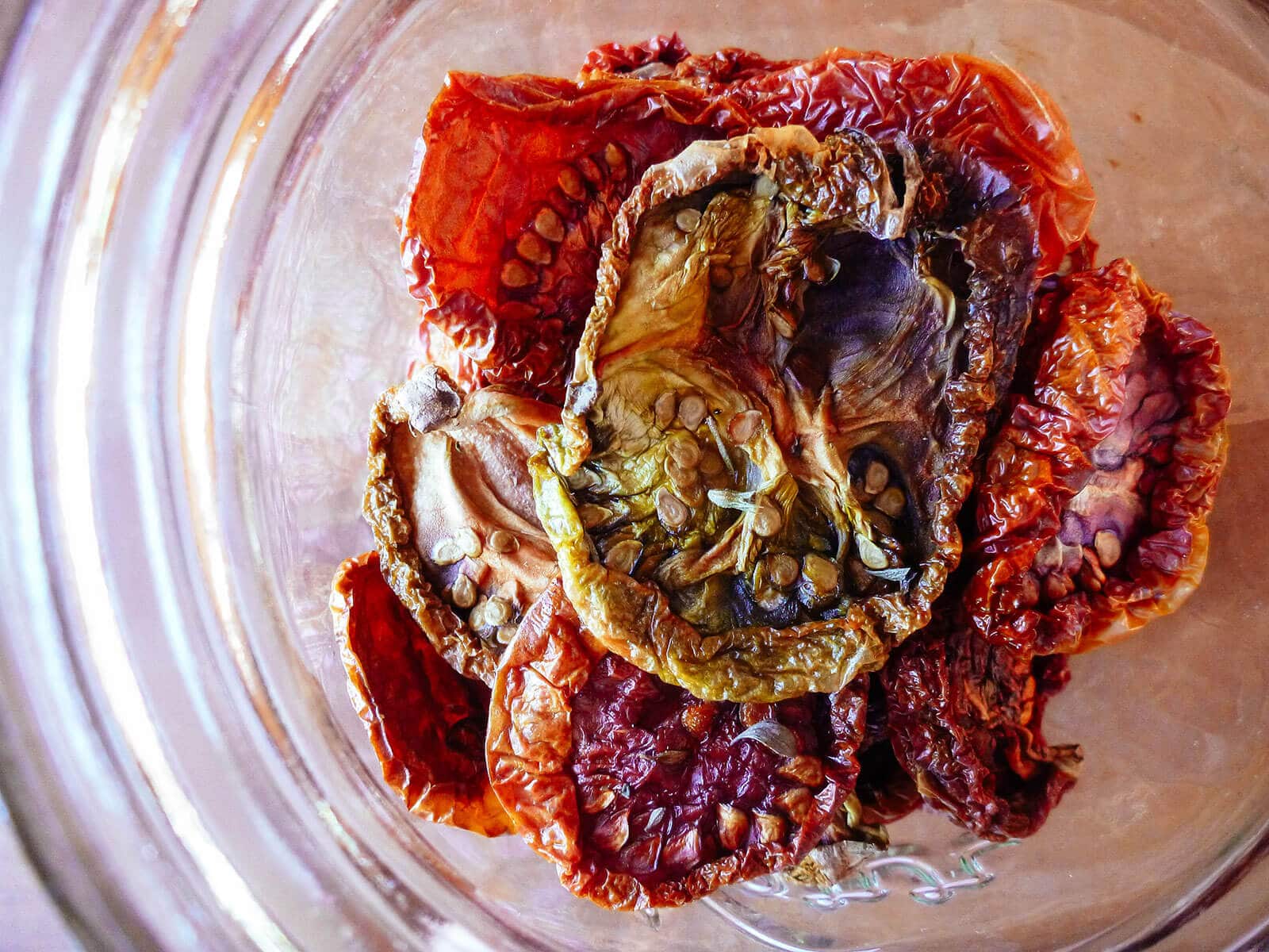 Close-up aerial view of oven-dried (sun-dried) tomatoes in a glass jar