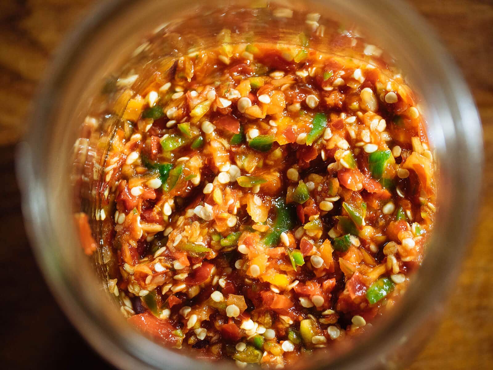 Aerial view of hot chile pepper mash in a jar