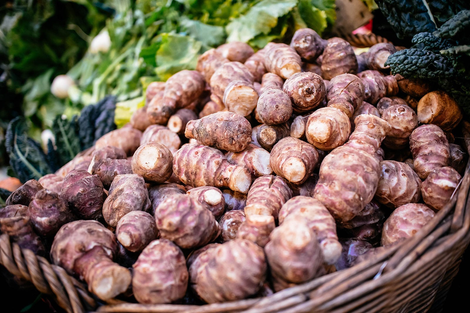 Pile of sunchokes in a basket at the farmers' market
